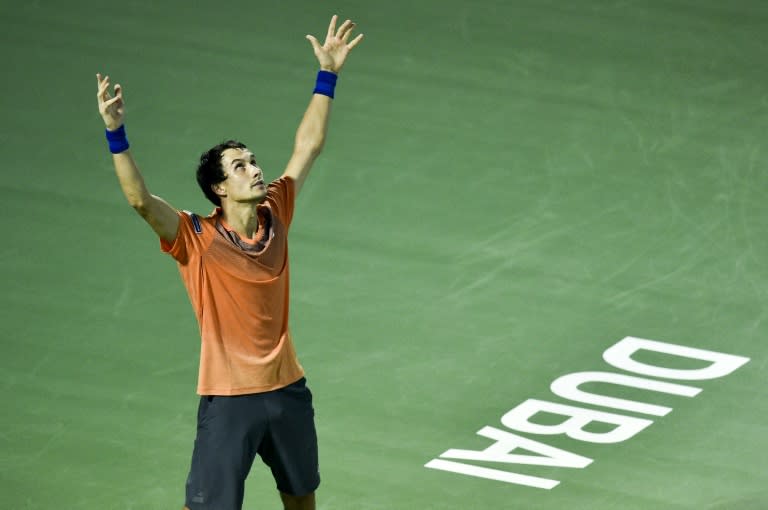 Evgeny Donskoy of Russia celebrates after winning his match against Switzerland's Roger Federer on March 1, 2017, in Dubai