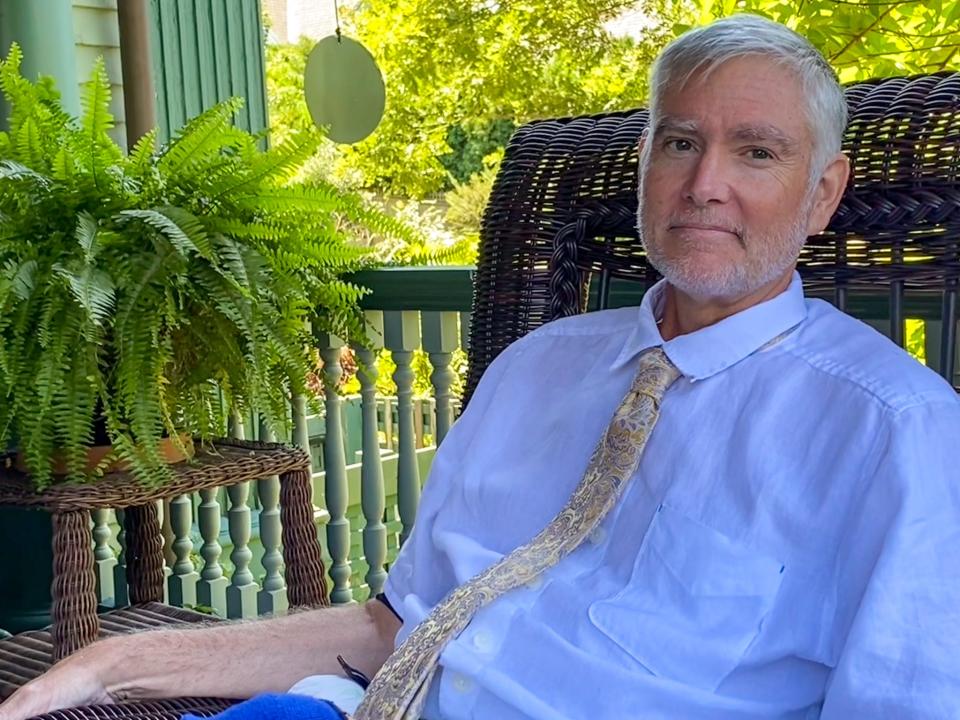 Jim Soule, president of the Preservation Society of Fall River, sits on the porch of his home on Rock Street on July 31, 2023.