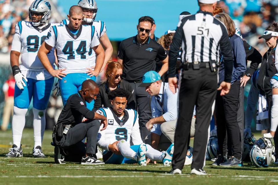 Carolina Panthers quarterback Bryce Young (9) holds his knee after an injury against the Jacksonville Jaguars during the first quarter at EverBank Stadium.