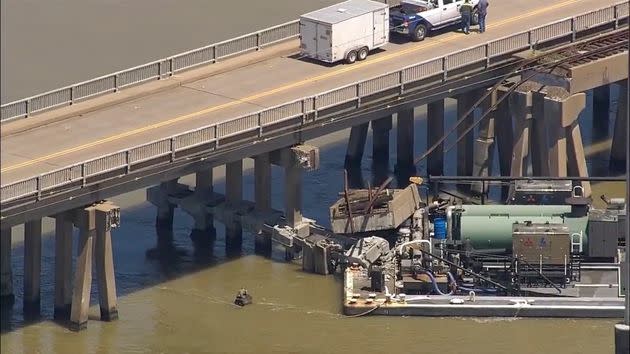 Oil spills into the surrounding waters after a barge hit a bridge in Galveston, Texas, on Wednesday, May 15.