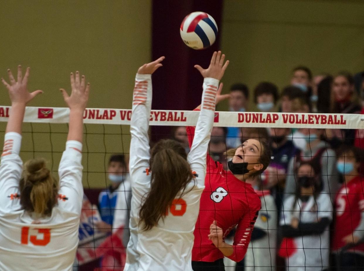 Metamora's Esma Frieden strikes the ball as Washington's Jori Dowling and Sam Puent jump to block during the class 3A sectional final at Dunlap High School on Wednesday, Nov. 3, 2021. The Redbirds beat the Panthers 2-0.