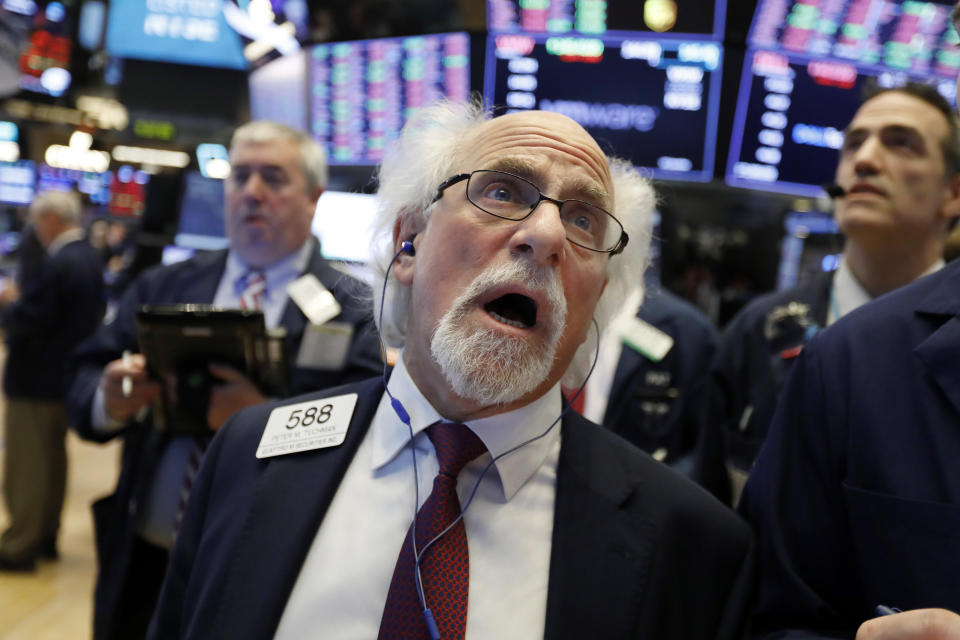 Trader Peter Tuchman works on the floor of the New York Stock Exchange, Monday, Jan. 14, 2019. Stocks are opening lower on Wall Street after China reported a surprise drop in exports to the U.S. last month. (AP Photo/Richard Drew)