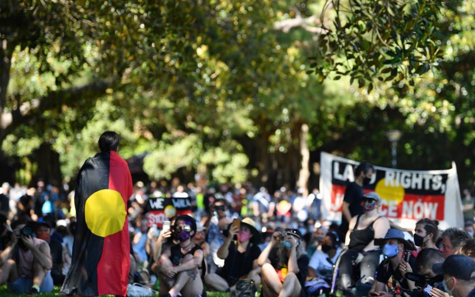 Indigenous and non-indigenous protesters during an Invasion Day rally in The Domain, Sydney - DEAN LEWINS/EPA-EFE/Shutterstock