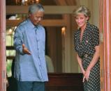 South African President Nelson Mandela, left, shows the way to Princess Diana, during in Cape Town, Monday, March 17 1997. (AP Photo/Sasa Kralj)