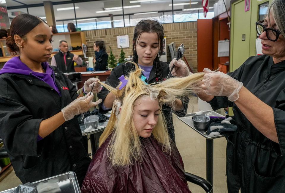 Ella Cobb gets her hair colored by students Nadia Zareas, left, and Ashley Vasquez, under the instruction of Debra Bjorklund, right, in a cosmetology class at the Newport Area Career and Technical Center.