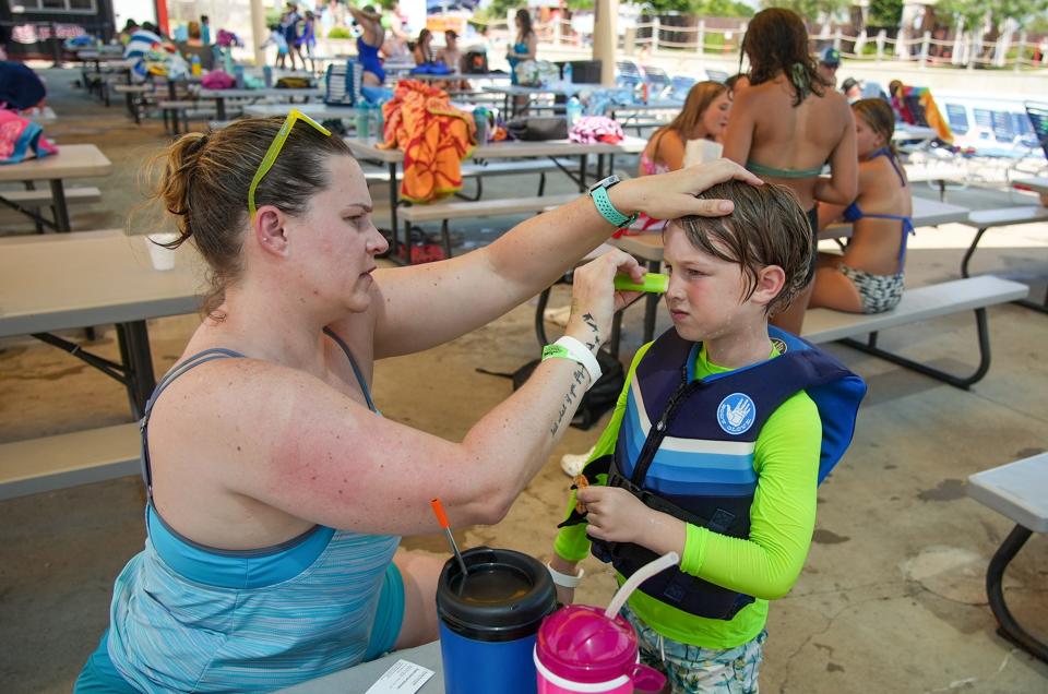 Mellissa Brown makes sure her son has on sunscreen at Typhoon Texas. Some medications make people more likely to burn from the sun.