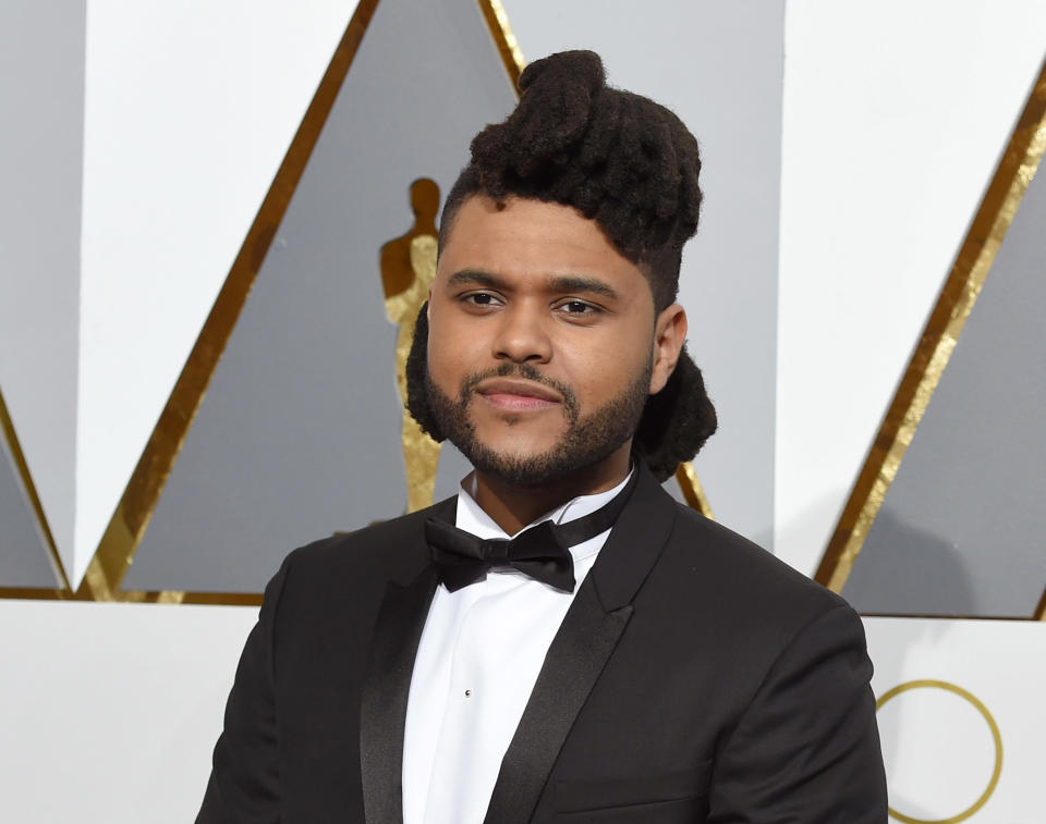 FILE - In this Feb. 28, 2016 file photo, The Weeknd arrives at the Oscars in Los Angeles. The Weeknd will team up for a performance with Daft Punk at the Grammy Awards on Feb. 12, 2017. The collaboration between the singer and the electronic music duo is one of a number of pairings announced Tuesday, Jan. 31, 2017. (Photo by Dan Steinberg/Invision/AP, File)