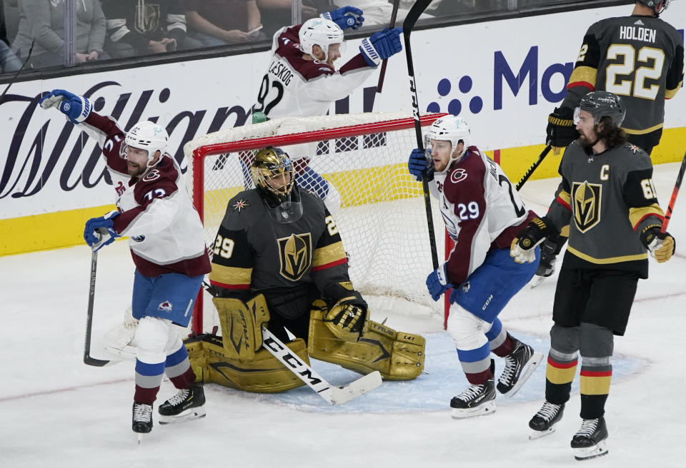 Colorado Avalanche right wing Joonas Donskoi, left, and center Nathan MacKinnon (29) celebrate after teammate Mikko Rantanen, not pictured, scored a goal against Vegas Golden Knights goaltender Marc-Andre Fleury (29) during the second period in Game 6 of an NHL hockey Stanley Cup second-round playoff series Thursday, June 10, 2021, in Las Vegas. (AP Photo/John Locher)