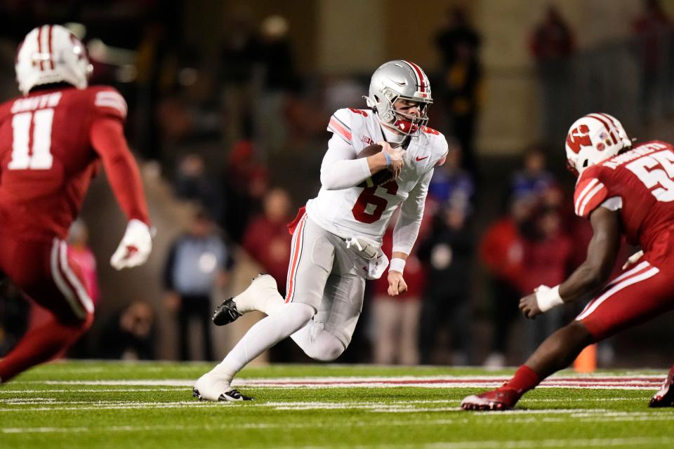 Oct 28, 2023; Madison, Wisconsin, USA; Ohio State Buckeyes quarterback Kyle McCord (6) scrambles out of the pocket toward Wisconsin Badgers linebacker Maema Njongmeta (55) during the second half of the NCAA football game at Camp Randall Stadium. Ohio State won 24-10.