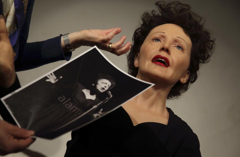 Paris' Grevin Wax Museum staff work around the statue of French singer Edith Piaf in their workshop in Paris