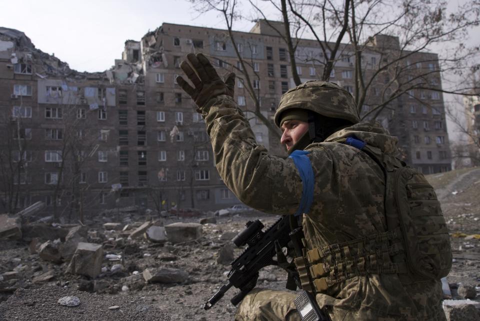 FILE - A Ukrainian serviceman guards his position in Mariupol, Ukraine, Saturday, March 12, 2022. Russia began evacuating its embassy in Kyiv, and Ukraine urged its citizens to leave Russia. Unbroken by a Russian blockade and relentless bombardment, the key port of Mariupol is still holding out, a symbol of staunch Ukrainian resistance that has thwarted the Kremlin's invasion plans. (AP Photo/Mstyslav Chernov, File)