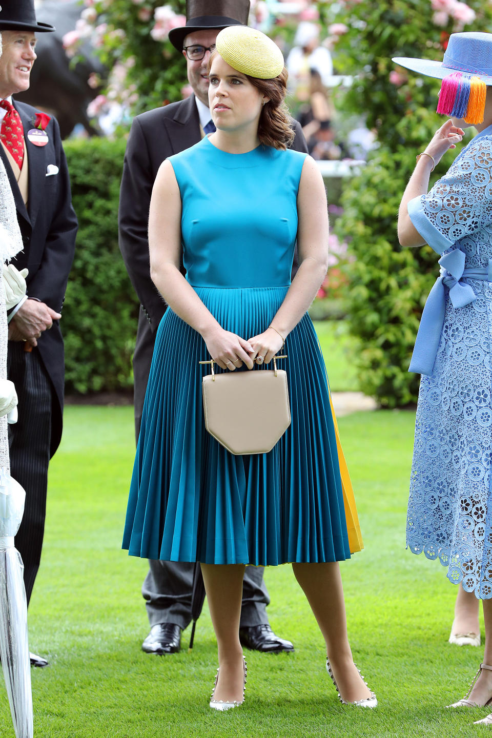 Eugenie wore a sleeveless look by Calvin Klein paired with a contrasting yellow hat. Photo: Getty