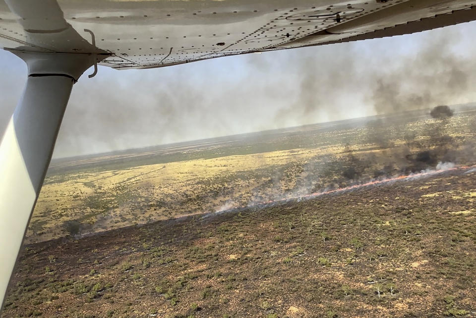 In this photo released by Bushfires NT, a large bushfire burns in the Outback of Australia near Tennant Creek in the Northern Territory, Wednesday, Sept. 13, 2023. Emergency crews were working to protect the Outback Australian town of Tennant Creek with containment lines on Wednesday as a huge wildfire threatened the remote community of 3,000. (Bushfires NT via AP)