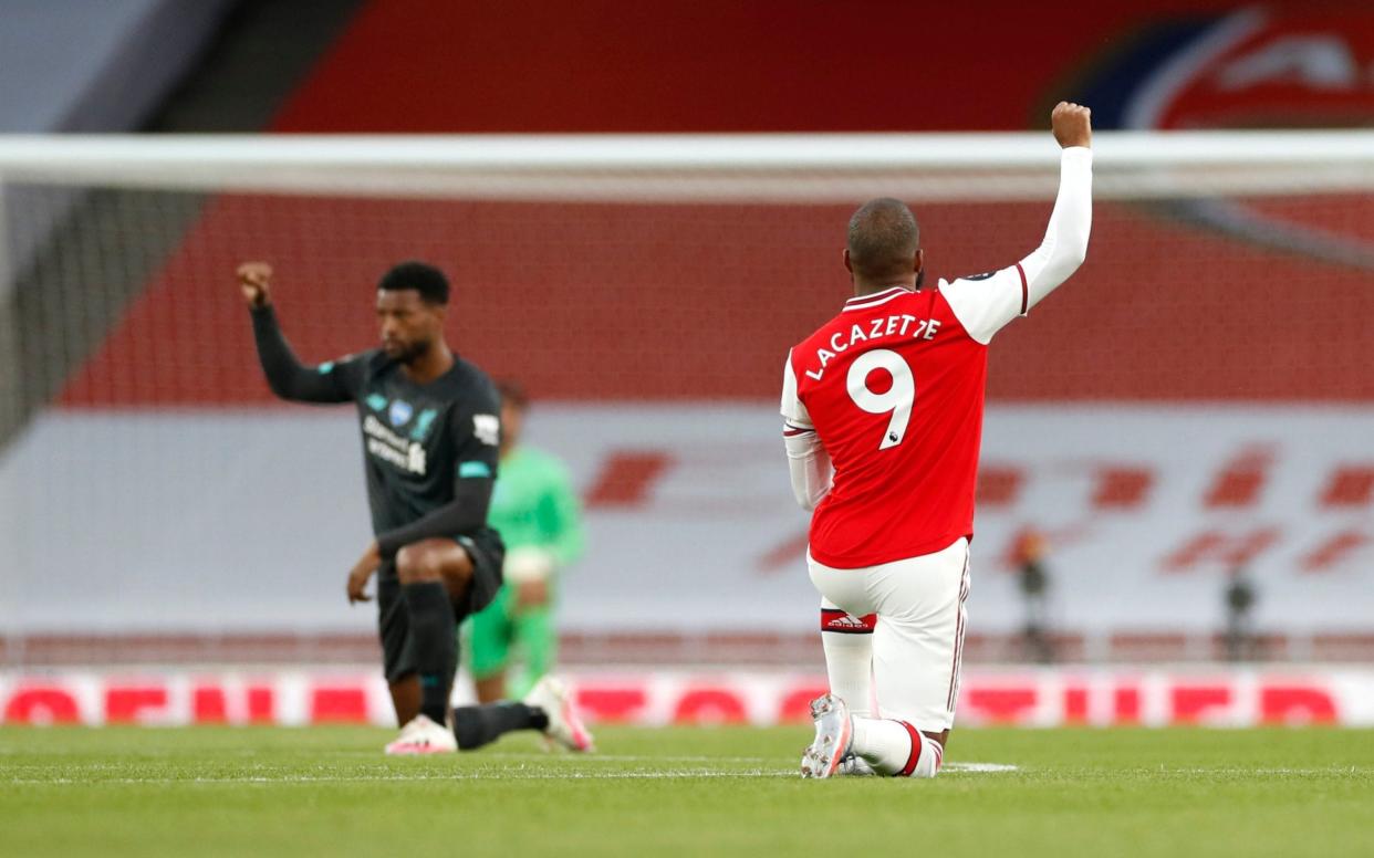 Arsenal's Alexandre Lacazette takes a knee in support of the Black Lives Matter movement - PA