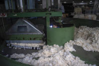 A worker performs maintenance work on a machinery at the Wenzhou Tiancheng Textile Company, one of China's largest cotton recycling plants in Wenzhou in eastern China's Zhejiang province on March 20, 2024. (AP Photo/Ng Han Guan)