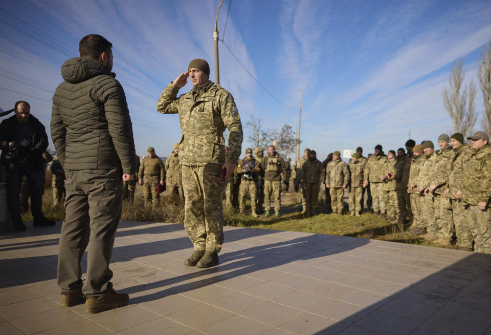 In this photo provided by the Ukrainian Presidential Press Office, Ukrainian President Volodymyr Zelenskyy, left, awards a serviceman during his visit to Kherson, Ukraine, Monday, Nov. 14, 2022. Ukraine's retaking of Kherson was a significant setback for the Kremlin and it came some six weeks after Russian President Vladimir Putin annexed the Kherson region and three other provinces in southern and eastern Ukraine — in breach of international law — and declared them Russian territory. (Ukrainian Presidential Press Office via AP)