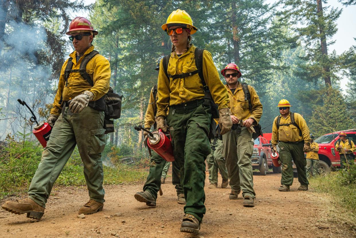 A crew of wildland firefighters make their way down the road to continue backburn operations at the Chalk Fire in July.