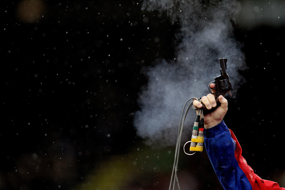 A starter fires a gun during Day One of the 2012 U.S. Olympic Track & Field Team Trials at Hayward Field on June 22, 2012 in Eugene, Oregon. (Photo by Christian Petersen/Getty Images)