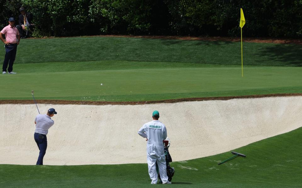Bryson DeChambeau of the U.S. plays out from the bunker on the 4th hole
