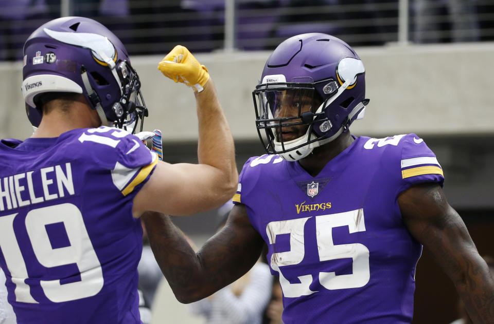 Minnesota Vikings running back Latavius Murray (25) celebrates with teammate Adam Thielen, left, after a 21-yard touchdown run during the first half of an NFL football game against the Arizona Cardinals, Sunday, Oct. 14, 2018, in Minneapolis. (AP Photo/Bruce Kluckhohn)