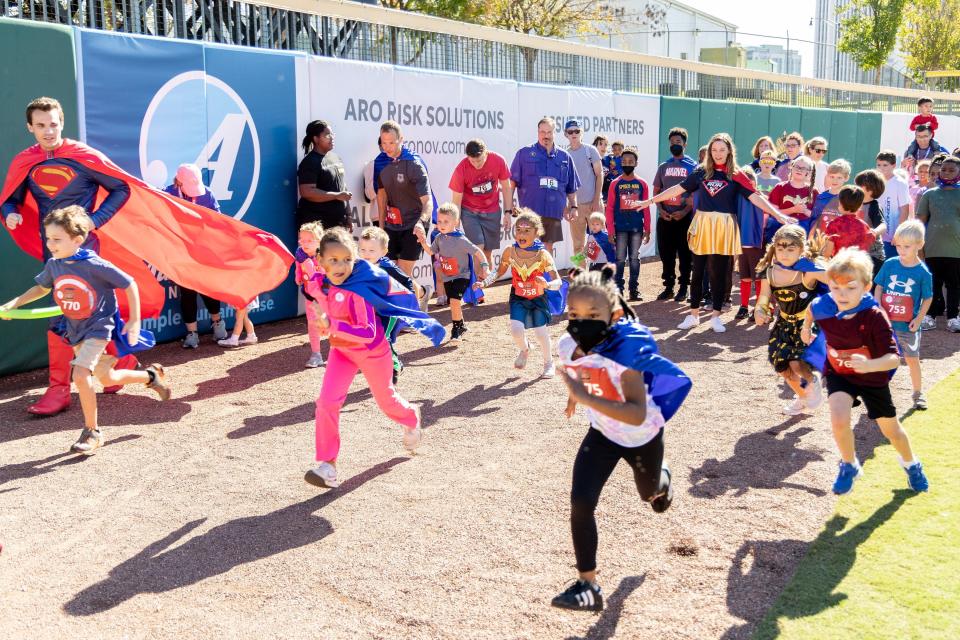 Kids and superheroes start a fun run during the Superhero Run hosted by CASA at downtown Montgomery's Riverwalk Stadium.