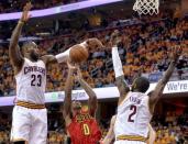 Cleveland Cavaliers forward LeBron James (23) and guard Kyrie Irving (2) guard Atlanta Hawks guard Jeff Teague (0) during the second half in game one of the second round of the NBA Playoffs at Quicken Loans Arena. The Cavs won 104-93. Mandatory Credit: Ken Blaze-USA TODAY Sports