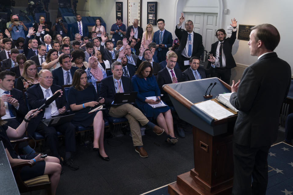 Journalists raise their hands to ask a question as White House national security adviser Jake Sullivan speaks during a press briefing at the White House, Monday, June 7, 2021, in Washington. (AP Photo/Evan Vucci)