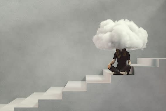 teenage woman sitting on the concrete stairs with a cloud covering her face