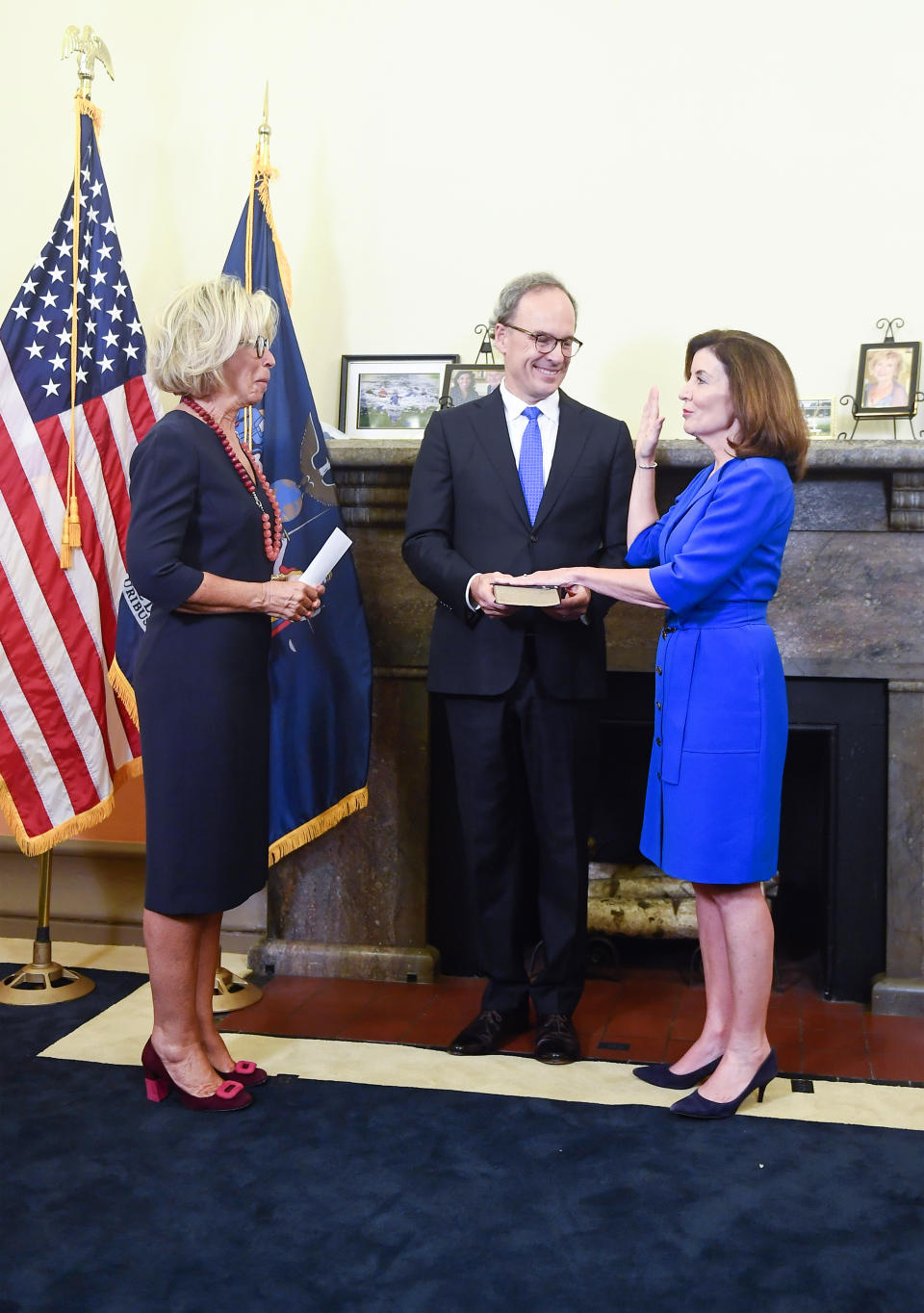New York Chief Judge Janet DiFiore, left, swears in Kathy Hochul, right, as the first woman to be New York's governor while her husband Bill Hochul holds a bible during a swearing-in ceremony in the Red Room at the state Capitol, early Tuesday, Aug. 24, 2021, in Albany, N.Y. (AP Photo/Hans Pennink, Pool)