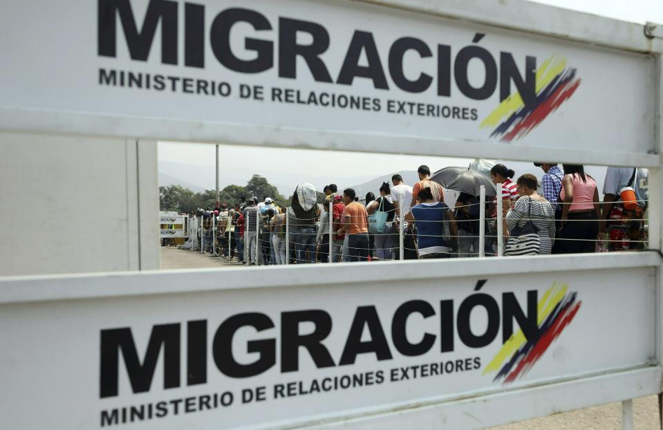 Venezuelan migrants return to their country after buying groceries in La Parada, on the outskirts of Cucuta, Colombia, on the border with Venezuela, Monday, Feb. 4, 2019. More than a dozen European Union countries endorsed Venezuelan opposition leader Juan Guaido as the county's interim president on Monday, piling the pressure on embattled President Nicolas Maduro to resign and clear the way for a new presidential election. (AP Photo/Fernando Vergara)