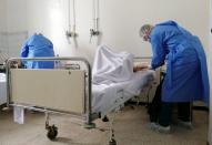 Medical staff assist COVID-19 patients at Charles Nicole Hospital in Tunis