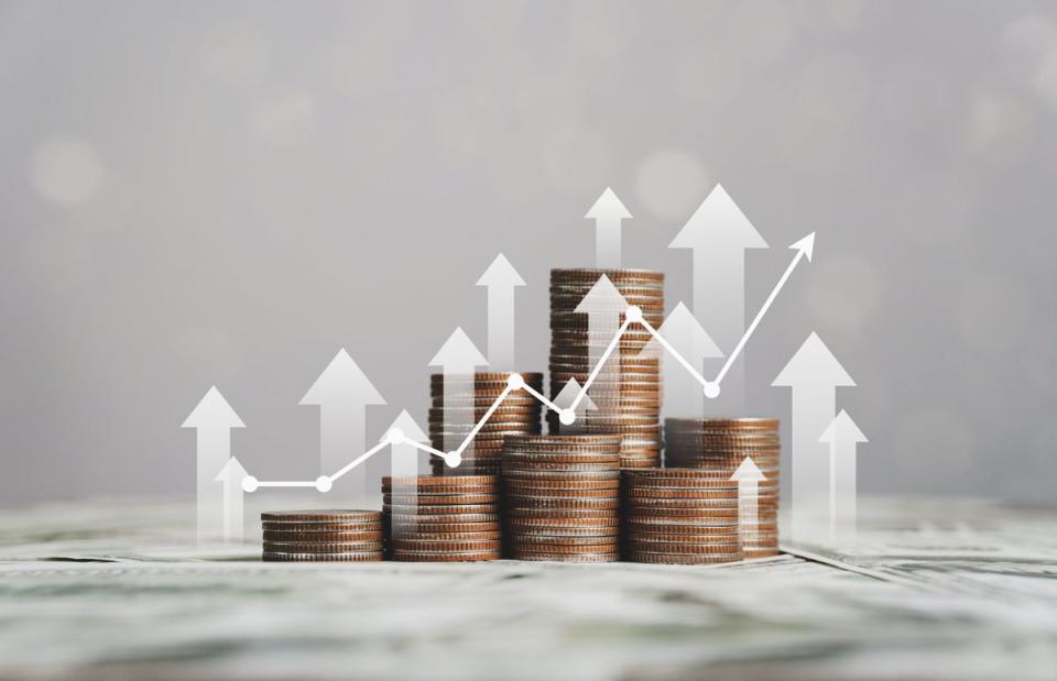 Stacks of coins with arrows pointing upward and a line chart trending upward.