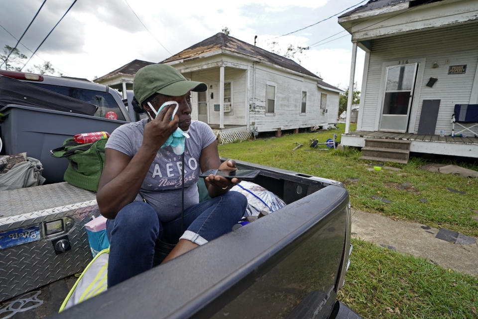 Linda Smoot, who evacuated from Hurricane Laura in a pickup truck with eight others, reacts as they return to see the damaged home of her niece for the first time, in Lake Charles, La., in the aftermath of the hurricane, Sunday, Aug. 30, 2020. (AP Photo/Gerald Herbert)