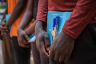 <p>Newly released child soldiers receive school supplies as part of a re-integration kit which includes clothing and mosquito nets during a release ceremony for child soldiers in Yambio, South Sudan on Feb. 7, 2018. (Photo: Stefanie Glinski/AFP/Getty Images) </p>