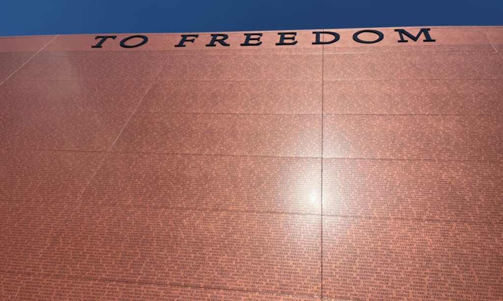 The sun is reflected in the National Monument to Freedom in Montgomery, Alabama on June 26, 2024. The monument is inscribed with the names of 122,000 families listed in the 1870 Census, the first in which many former enslaved people were recorded. (Brian Lyman/Alabama Reflector)