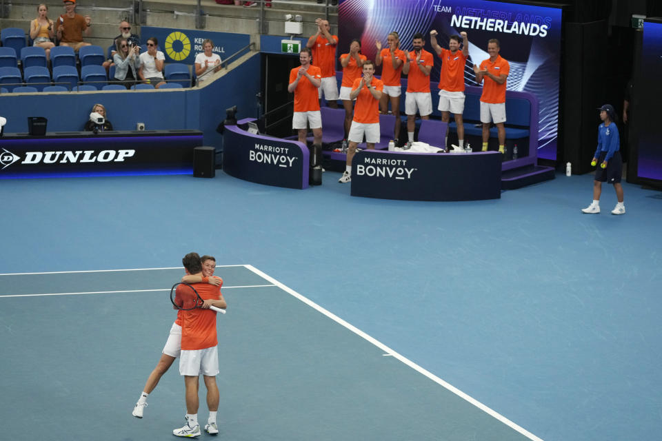 Netherlands' double players Demi Schuurs, bottom right, and Wesley Koolhof embrace as their team celebrate their win over Norway during the United Cup tennis tournament in Sydney, Saturday, Dec. 30, 2023. (AP Photo/Rick Rycroft)