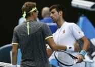 Tennis - Australian Open - Melbourne Park, Melbourne, Australia - 19/1/17 Uzbekistan's Denis Istomin embraces Serbia's Novak Djokovic after winning their Men's singles second round match REUTERS/Issei Kato