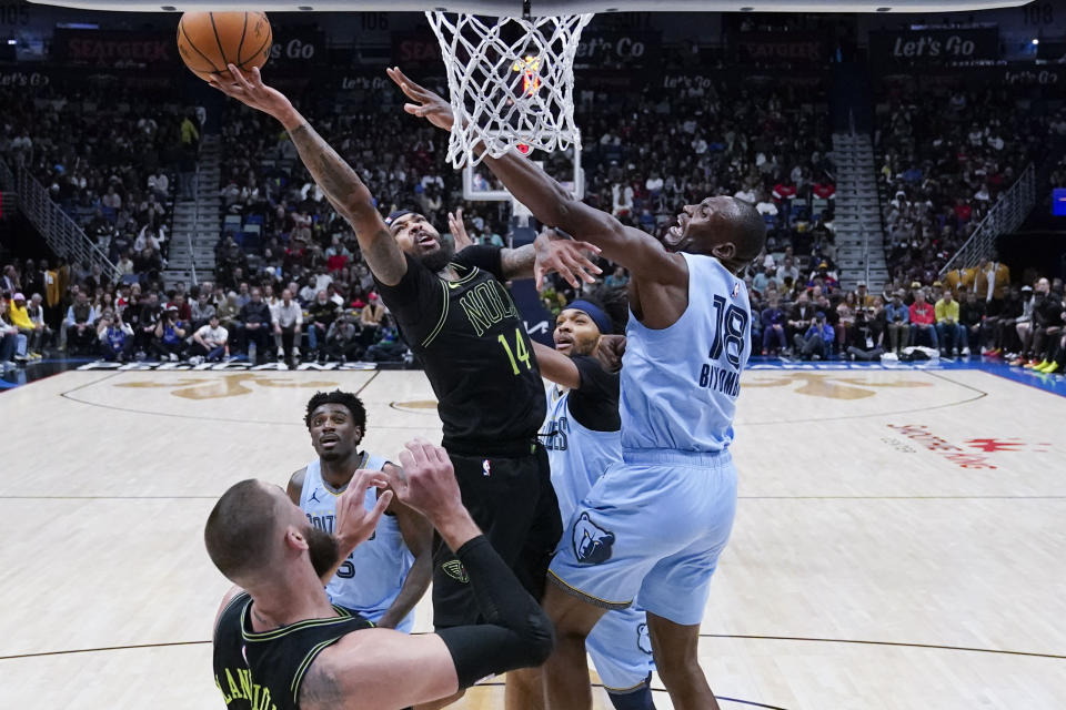 New Orleans Pelicans forward Brandon Ingram (14) goes to the basket against Memphis Grizzlies center Bismack Biyombo (18) in the first half of an NBA basketball game in New Orleans, Tuesday, Dec. 26, 2023. (AP Photo/Gerald Herbert)