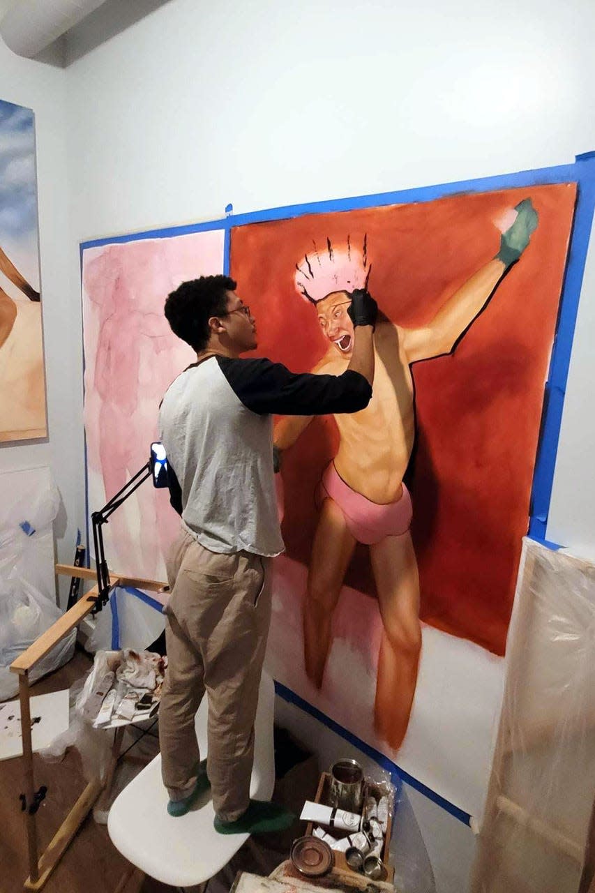 Davon Brantley works on a piece in his studio.