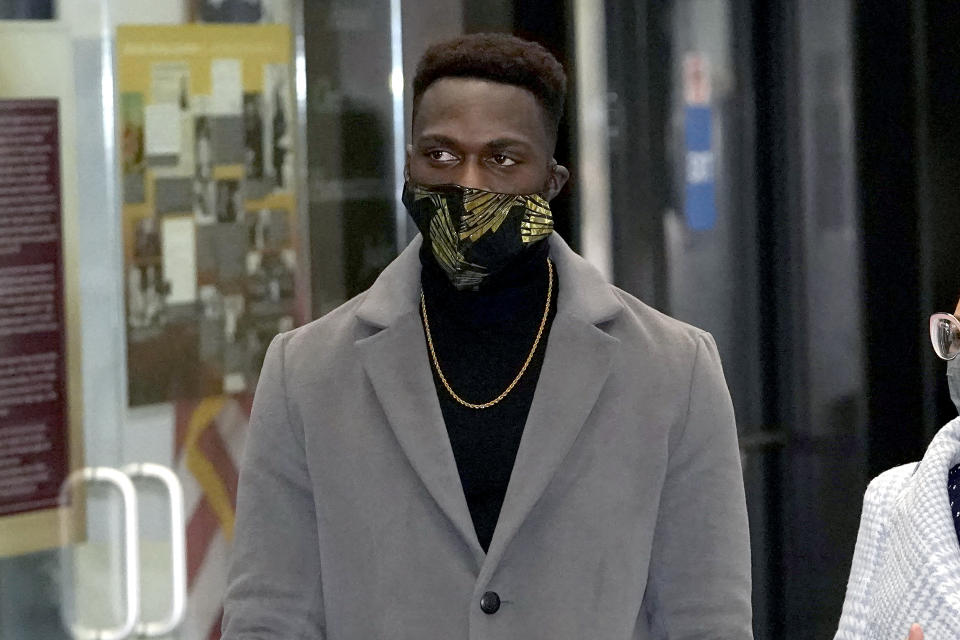 Abimbola "Able" Osundairo heads to a courtroom at the Leighton Criminal Courthouse in Chicago, where he is expected to testify in the trial of actor Jussie Smollett, Wednesday, Dec. 1, 2021. Smollett is accused of lying to police when he reported he was the victim of a racist, anti-gay attack in downtown Chicago nearly three years ago. (AP Photo/Charles Rex Arbogast)