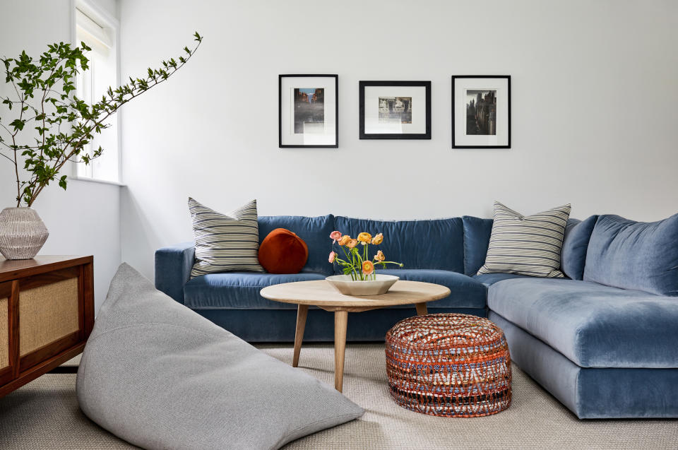 blue velvet corner sofa in white living room