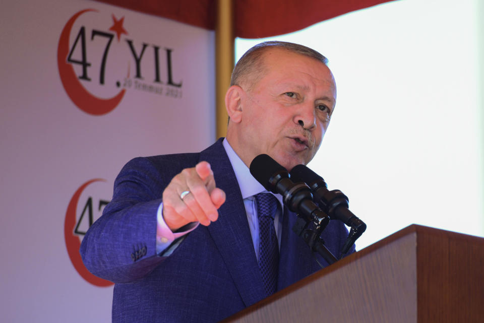 Turkish President Recep Tayyip Erdogan, talks before the military parade marking the 47th anniversary of the 1974 Turkish invasion in the Turkish occupied area of the divided capital Nicosia, Cyprus, Tuesday, July 20, 2021. The only route to lasting peace on ethnically divided Cyprus is through the international community's acceptance of two separate states on the east Mediterranean island nation, Turkey's president said. (AP Photo/Nedim Enginsoy)