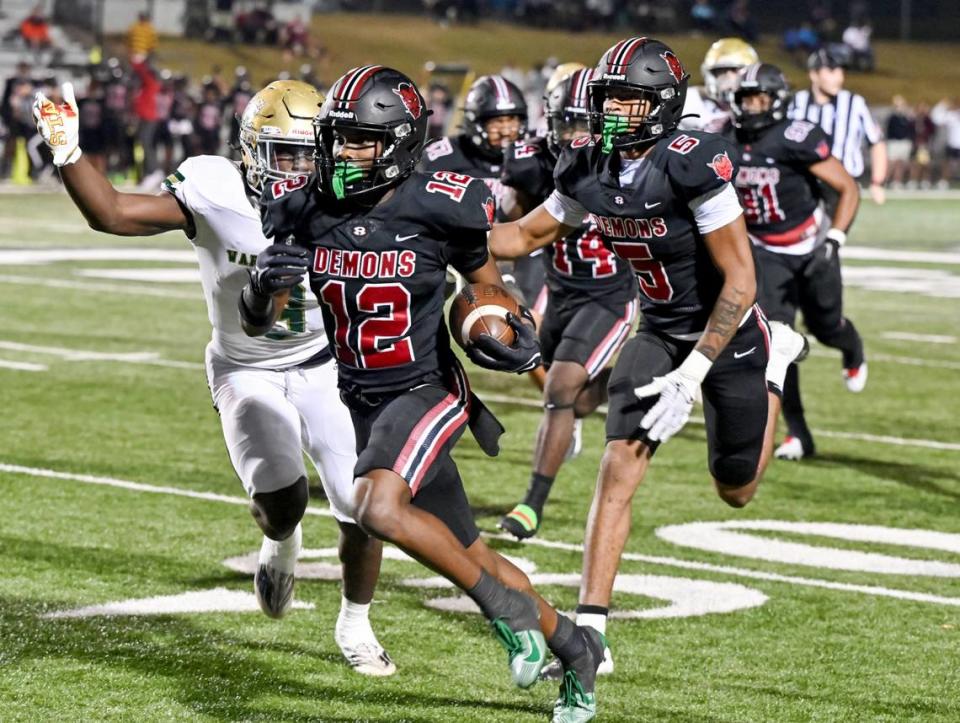 Warner Robins defensive back Myles Joyner (12) returns an interception down the sidelines during the Demons’ second round playoff game against Ware County Friday night.