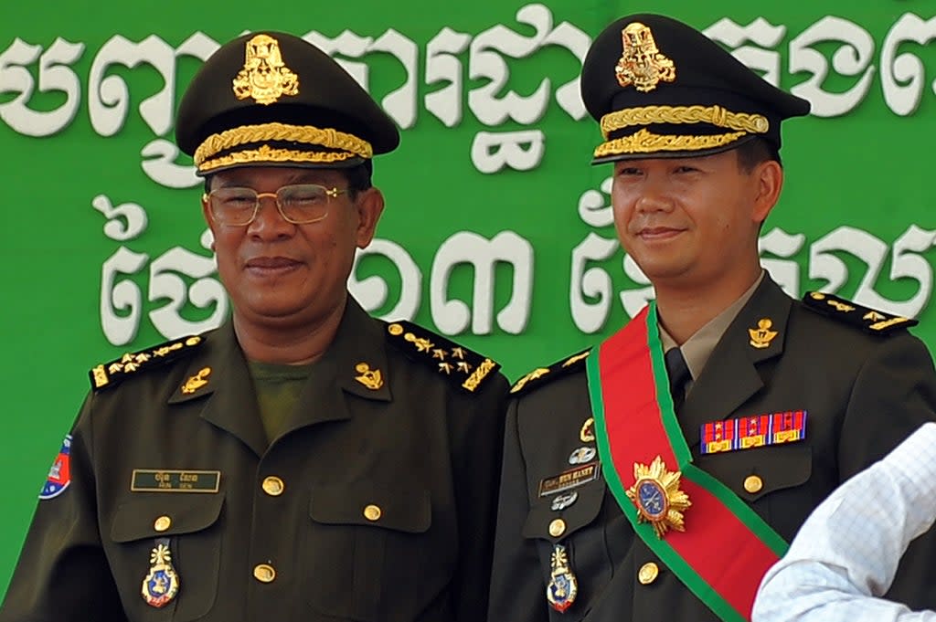 File: Cambodian prime minister Hun Sen (L) poses with his son Hun Manet (R) during a ceremony at a military base in Phnom Penh  (AFP via Getty Images)