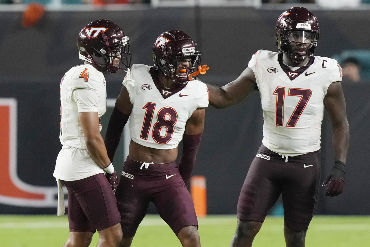 Virginia Tech safety Mose Phillips III (18) celebrates intercepting a pass during the first half of an NCAA college football game against Miami, Friday, Sept. 27, 2024, in Miami Gardens, Fla. (AP Photo/Marta Lavandier)