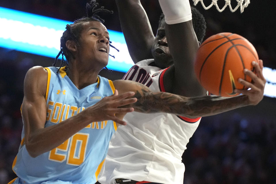 Southern University guard Gavin Harris (20) drives against Arizona center Oumar Ballo during the first half of an NCAA college basketball game, Friday, Nov. 11, 2022, in Tucson, Ariz. (AP Photo/Rick Scuteri)