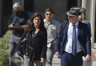 Marianne Campbell Smith, left, and her attorney, Frederick W. Fascenelli leave the West Justice Center, Wednesday, Oct. 20, 2021, in Westminster, Calif., during a lunch break in her trial. Smith, who refused to leave a Costa Mesa grocery store, was convicted of trespassing on Wednesday after becoming the only person to go on trial in Orange County for not following pandemic-driven face-covering mandates at local businesses. (Jeff Gritchen/The Orange County Register via AP)