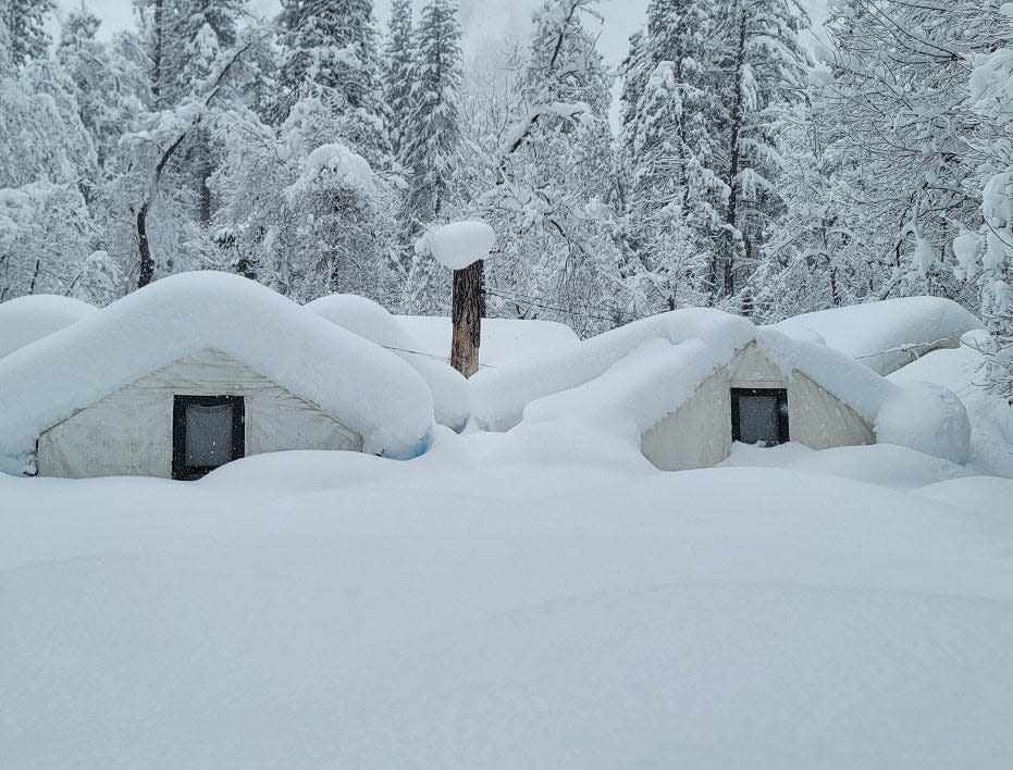 In this photo provided by the National Park Service, tents at Curry Village are covered with snow in Yosemite National Park, Calif., Tuesday, Feb. 28, 2023. The park, closed since Saturday because of heavy, blinding snow, postponed its planned Thursday, March 2, 2023, reopening indefinitely.