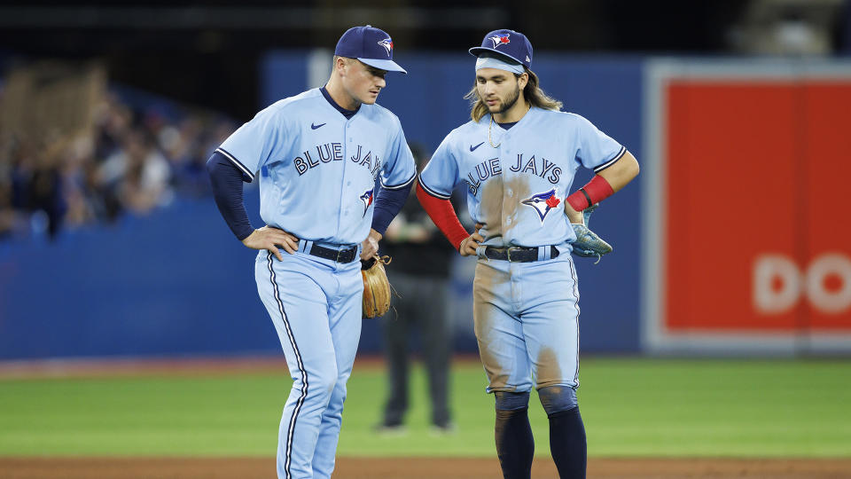 Bo Bichete, right, and Matt Chapman both left the Blue Jays' game against the Cleveland Guardians on Sunday. (Photo by Cole Burston/Getty Images)