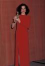 <p>Sigourney Weaver in a scarlet column gown with asymmetrical sleeves. </p>